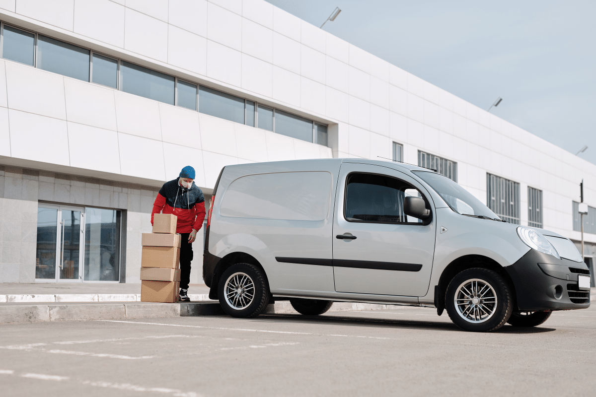 delivery-man-with-boxes-next-to-a-white-van-4391470